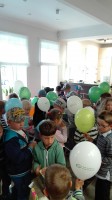 Dzieci trzymające balony oglądające otrzymane prezenty